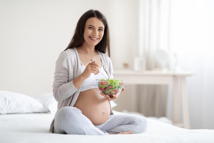 pregnant-woman-eating-healthy-meal-home_116547-36357